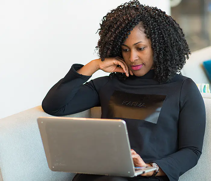 Woman Using a Laptop Computer to Contact Whitechapel Behavioral Services
